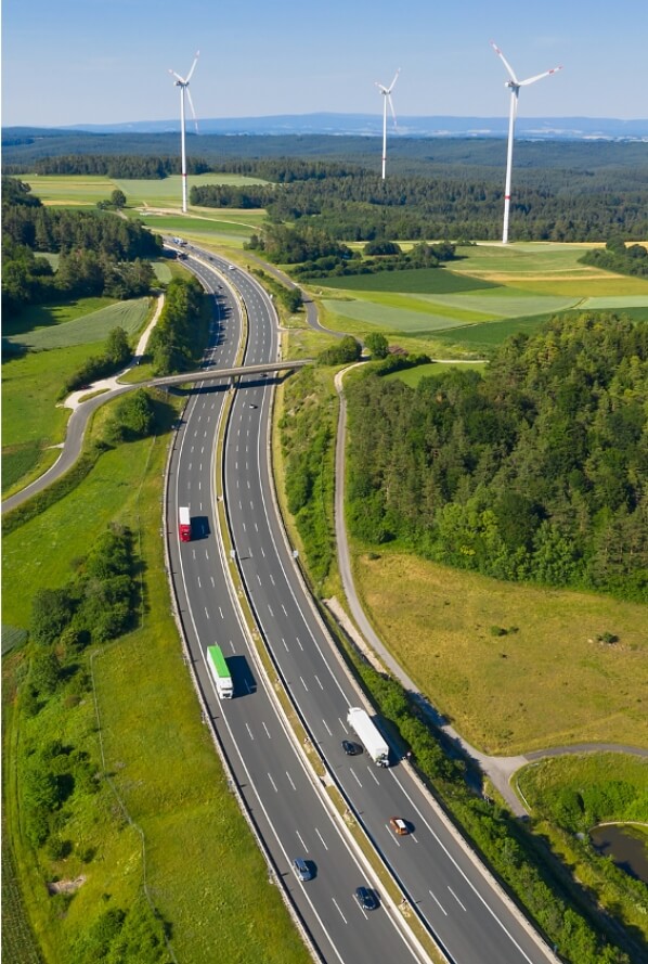 Wind turbines in distance with motorway in foreground